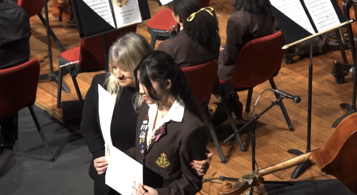 Veronica receiving an award on stage
